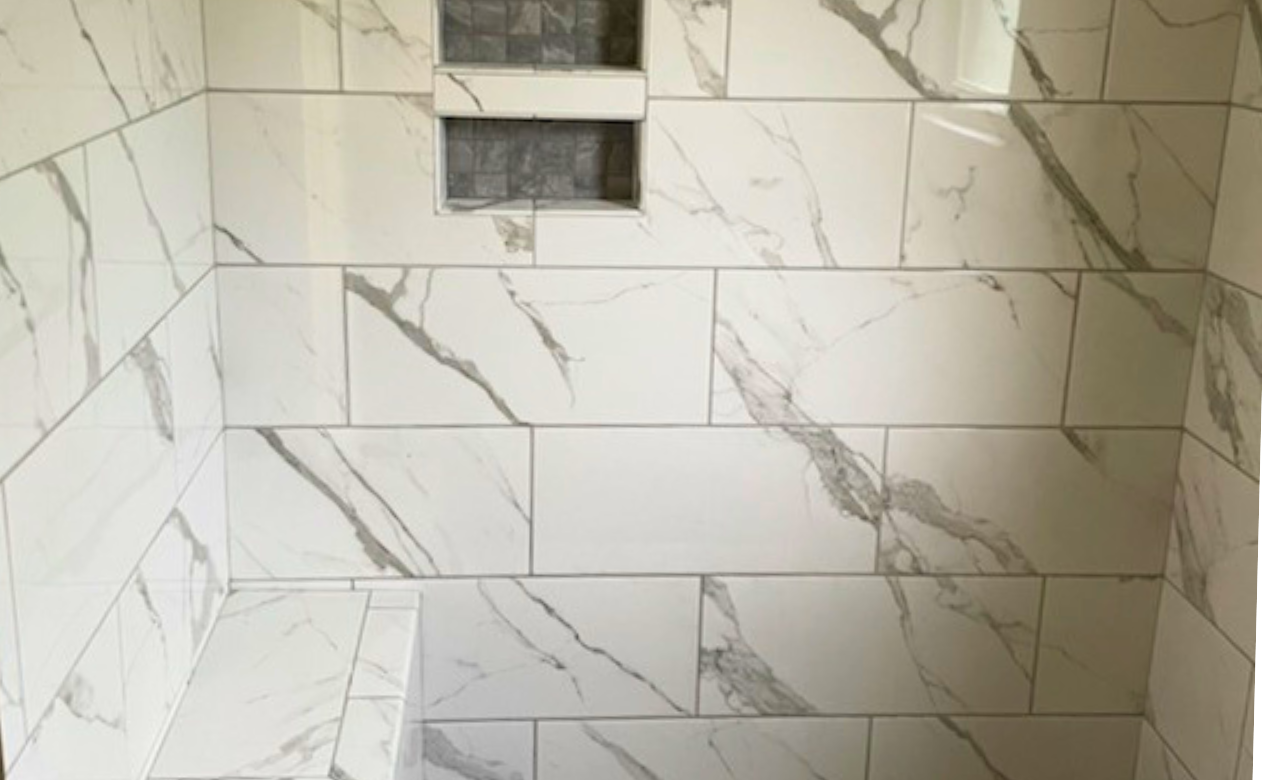 Custom tiled shower with niche and bench from Wheat's Carpet