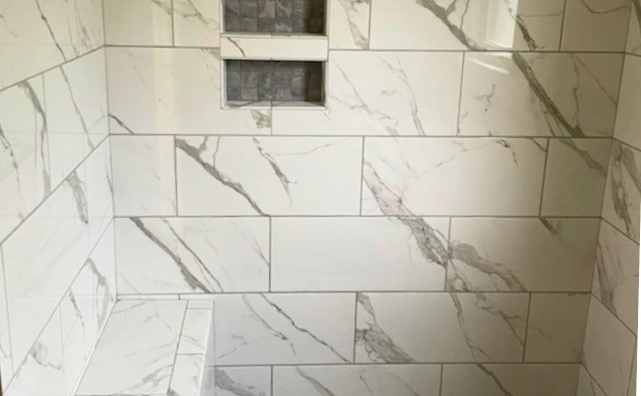 Custom tiled shower with niche and bench from Wheat's Carpet
