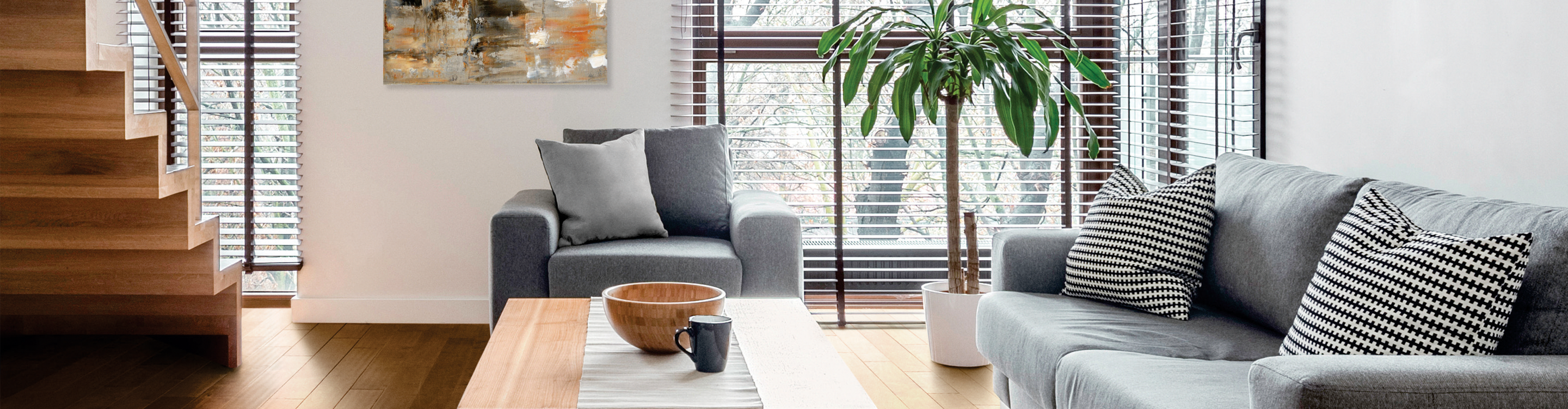 graber window treatment blinds in living room with gray sofa and light hardwood floors